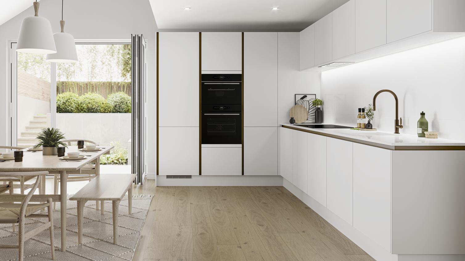 Contemporary L-shaped white kitchen idea with matt slab cupboard doors and a handleless design. Has white trims and worktops.